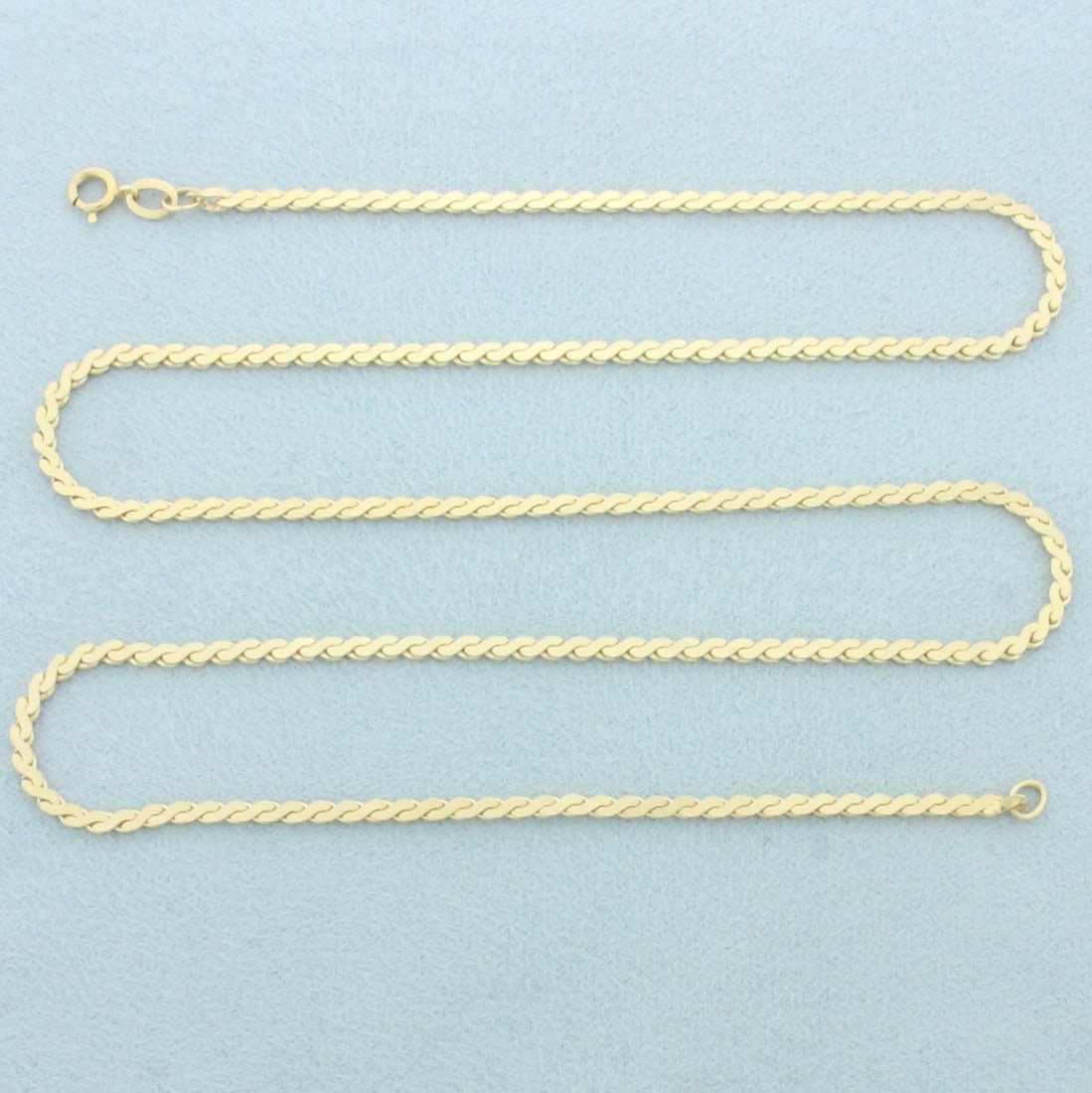 18 Inch Serpentine S Link Chain Necklace in 14k Yellow Gold: In 14k yellow gold. 18 inches long and 2mm wide. Spring Ring Clasp. 7.0g.