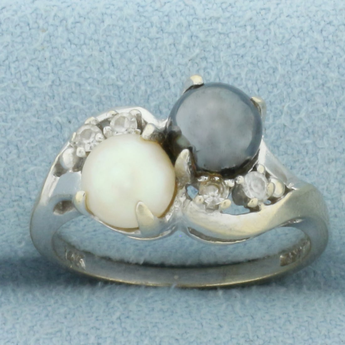 Tahitian, Akoya Pearl and Diamond Toi Et Moi Ring in 14k White Gold: In 14k white gold. Contains one high quality 6mm Tahitian black pearl and one 6mm high quality cultured Akoya pearl, both with high luster. Also contains four .02ct high quality diamonds, SI clarity/H