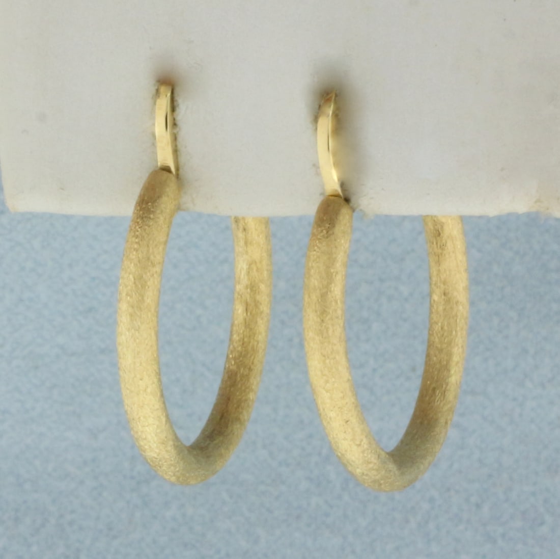 Sandblast Finish Hoop Earrings in 22k Yellow Gold: In 22k yellow gold. 1 inch long x 3/4 inches wide. Sandblast finish. 3.5g.