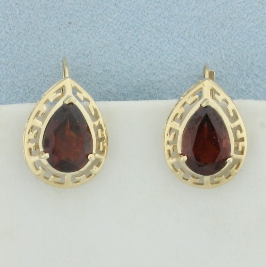 Garnet Drop Earrings In 10k Yellow Gold: In 10k yellow gold. Contains two high quality natural 10mm by 7mm Garnet gemstones, 2cts each, with deep color and excellent clarity. 3/4 inches by 1/2 inch. 2.7g.
