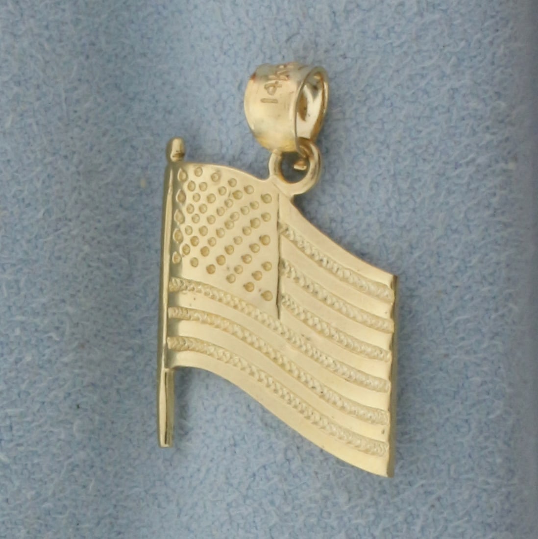 USA American Flag Pendant in 14k Yellow Gold: In 14k yellow gold. 7/8 inches long x 5/8 inches wide. 1.6g.