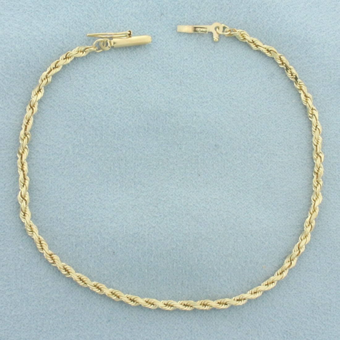 Rope Link Bracelet in 14k Yellow Gold: In 14k yellow gold. 7 1/4 inches long and 2.3mm wide. Safety clasp. 3.4g.