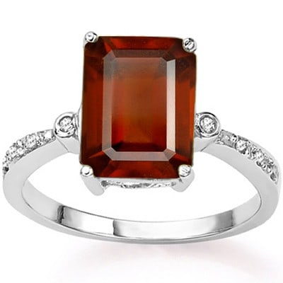 4CT Garnet and Diamond Ring in Sterling Silver: Emerald cut 4.1ct natural garnet gemstone ring accented with .01ctw genuine diamonds. Garnet has small inclusion. Size 7. Set in platinum over sterling silver, 2.7g.