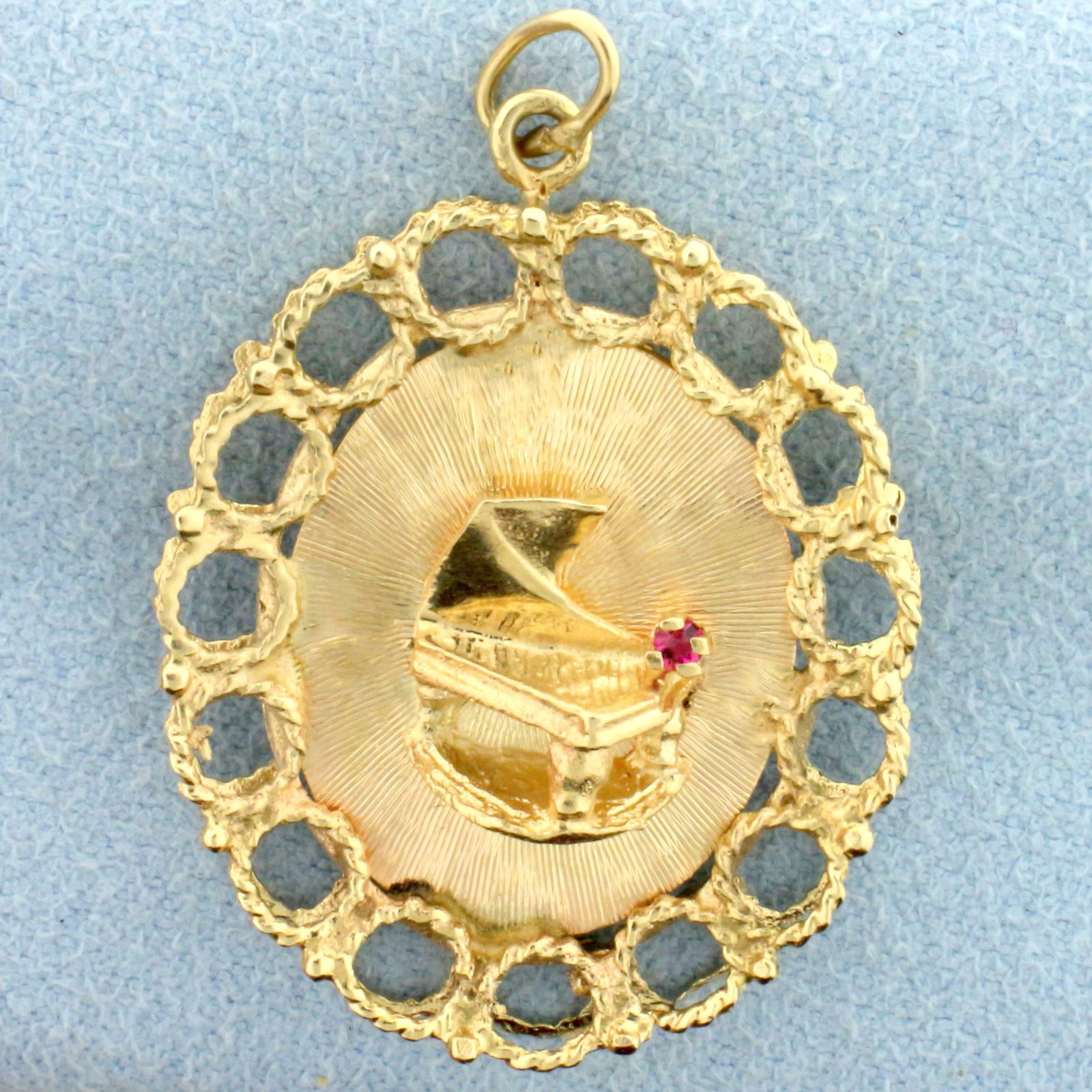 Pink Sapphire 3D Piano Pendant in 14k Yellow Gold: In 14k yellow gold. Contains one high quality natural .01ct Pink Sapphire with intense color. Measures 1 3/8inches long, 1 inch wide. 4.0g.