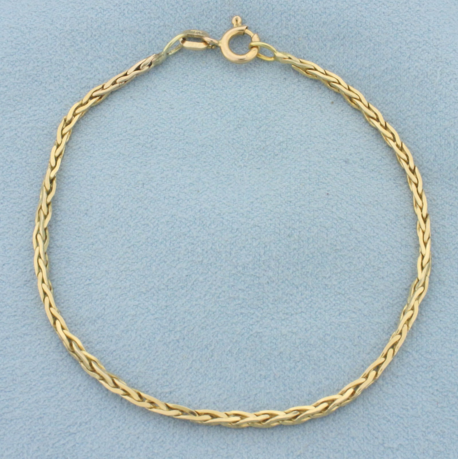 Italian Wheat Link Chain Bracelet in 14k Yellow Gold: In 14k yellow gold. 7 inches long, 1.5mm wide. Spring Clasp. 3.3g.