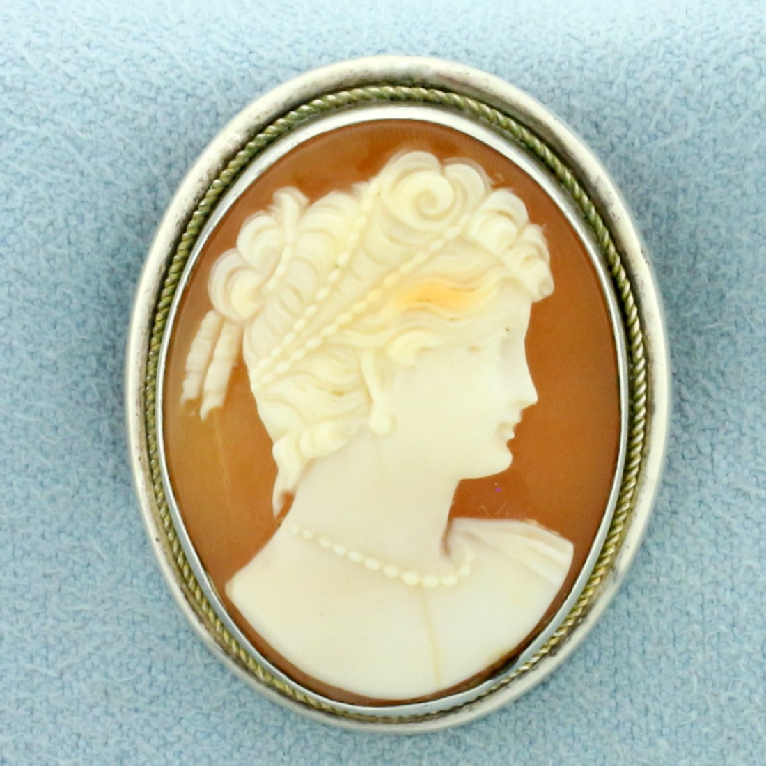 Vintage Hand Carved Shell Cameo Pin Pendant in Silver: In .800 silver. 1 1/8 inches long x 7/8 inches wide. Can be worn as pin or pendant - retracting bale. 6.0g.