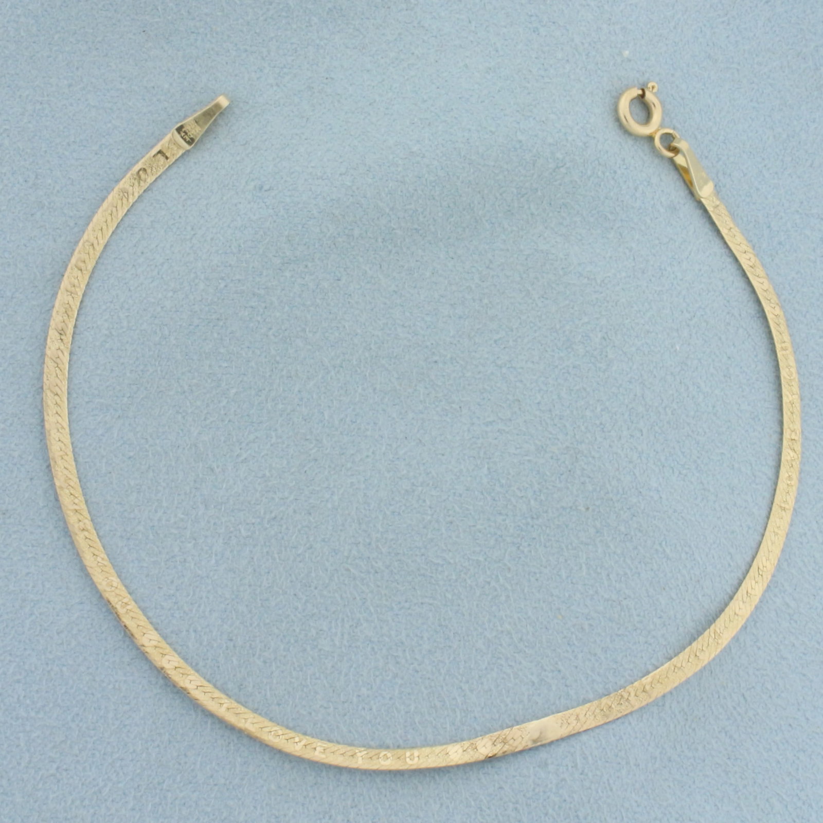 I Love You Reversable Herringbone Bracelet in 14k Yellow Gold: In 14k yellow gold. Italian made. 7 inches long and 2.2m wide. One side says I love you with hearts, the other is standard herringbone link, 2 bracelets in one. Spring Ring Clasp. One spot was repaire