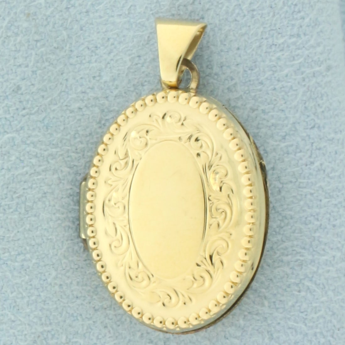 Antique Locket: 14k yellow gold bale and gold plated locket. 1 1/16 inches long and 5/8 inches wide. 1.7g.