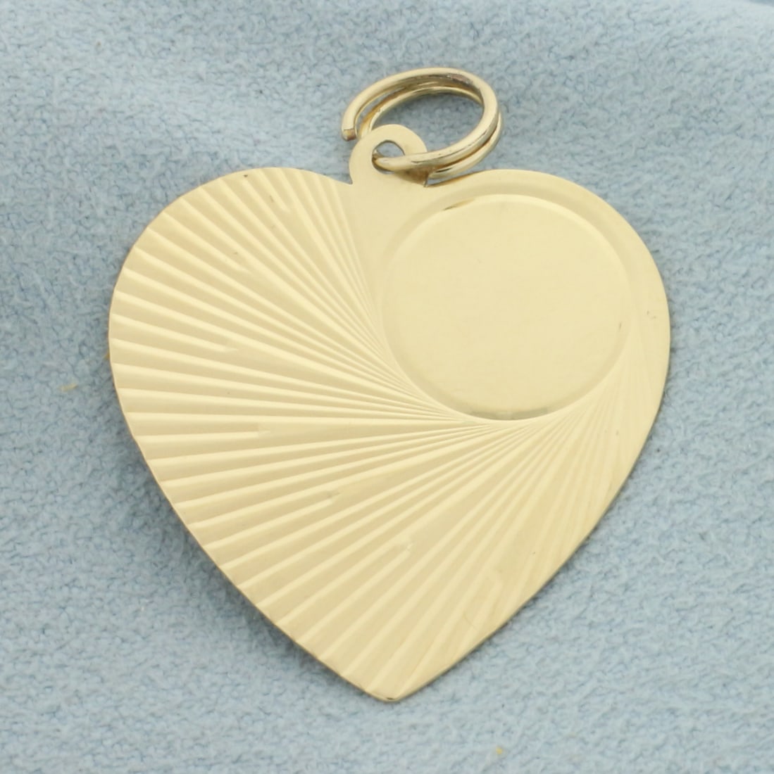 Engravable Heart Charm or Pendant in 14k Yellow Gold: In 14k yellow gold. 1 1/4 inches long by 1 inch wide. Can engrave within circle on front or on back. 2.1g.