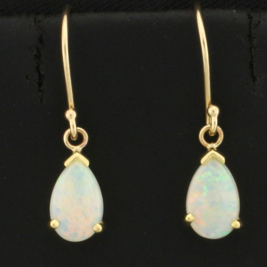 Opal Dangle Drop Earrings in 18k and 14k Yellow Gold: In 18k yellow gold mountings on 14k Yellow Gold hooks. Contains two high quality natural 8mm pear shaped opal gemstones with excellent play of color and flashes of red, yellow, and green. 7/8 inches l