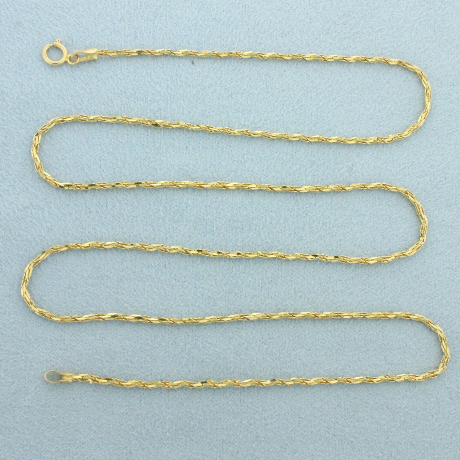 Italian Twisting Boston Link Chain Necklace in 14k Yellow Gold: In 14k yellow gold. Italian made. 20 inches long and 1.3mm wide. Spring ring clasp. 2.7g.