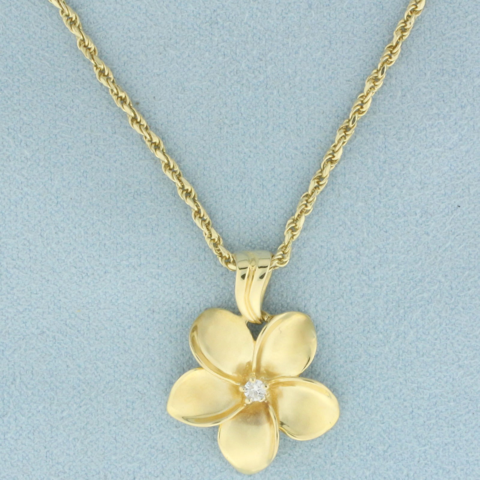 Hawaiian Plumeria Flower Diamond Necklace in 14k Yellow Gold: In 14k yellow gold. Contains one high quality .05ct diamond, VS clarity/G color. Pendant is 1 inch long (including bale) x 3/4 inches wide. Rope link chain is 16 1/2 inches long and 1.8mm wide, with l