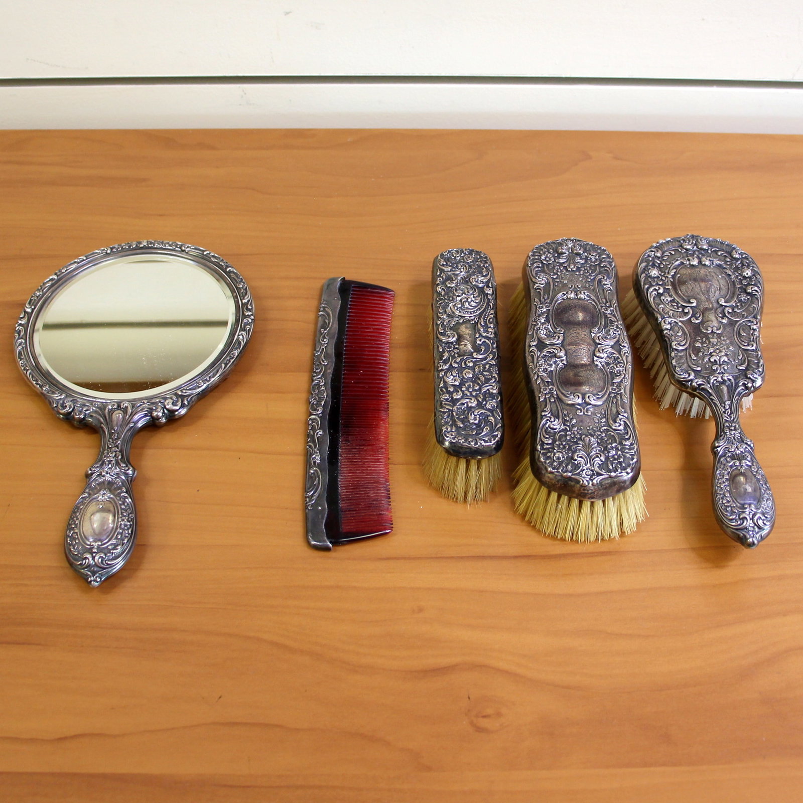 Antique Sterling Silver Vanity 5-Piece Set: Set includes bristle hair brush (8 inches), comb-Gorham #23 (7.5 inches) , mirror (9.5 inches), clothes brush-large-Gorham c1456 (7 inches), Garment brush-medium (7 inches) Monograms as shown. Fantast