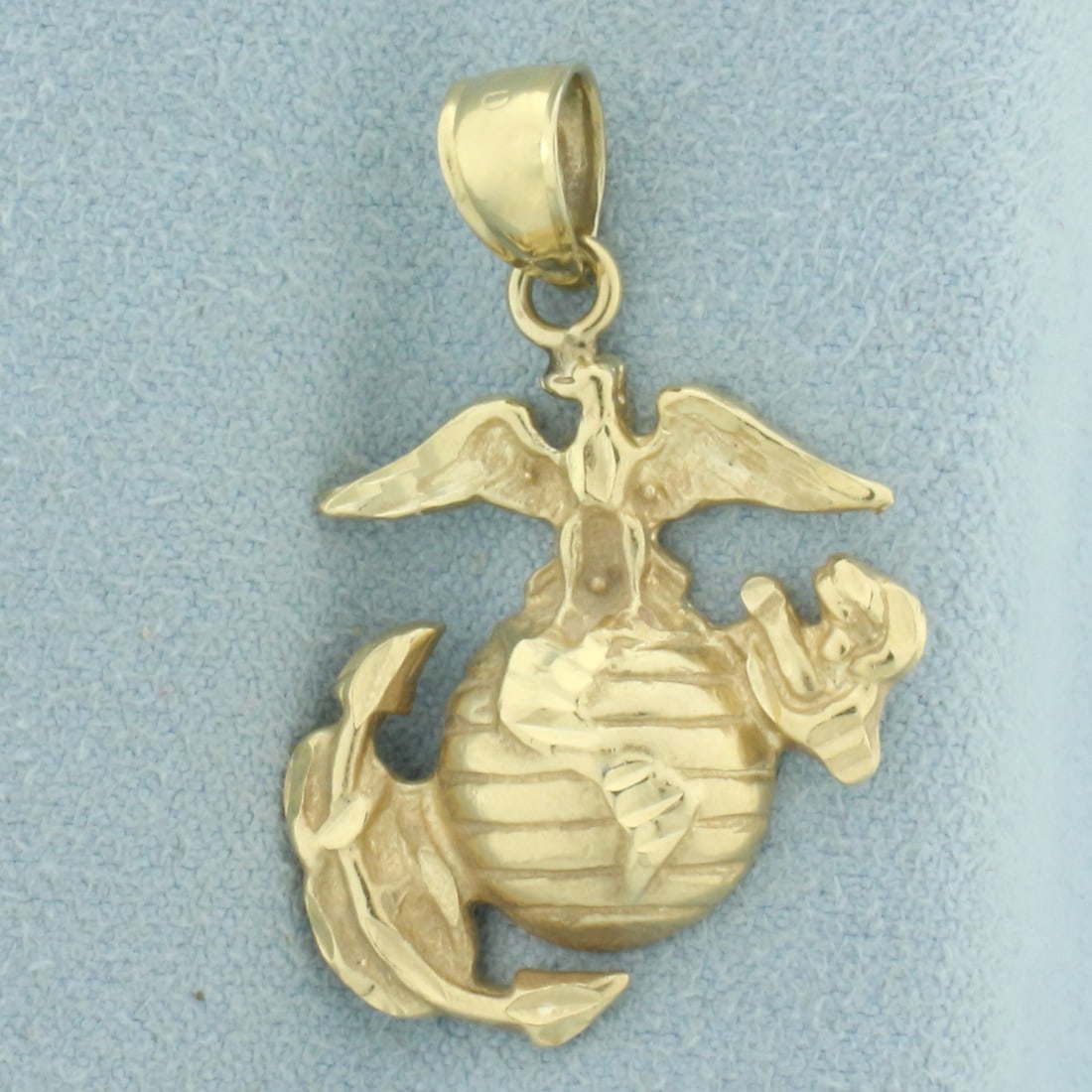 US Marine Corps Pendant in 14k Yellow Gold: In 14k yellow gold. 1 1/4 inches long by 7/8 inches wide. 3.8g.