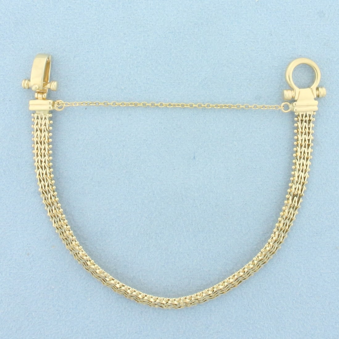 Designer Link Bracelet in 14K Yellow Gold: In 14K Yellow Gold. Approximately 6 3/4 inches long, 6mm wide. Safety chain. 11.7g.