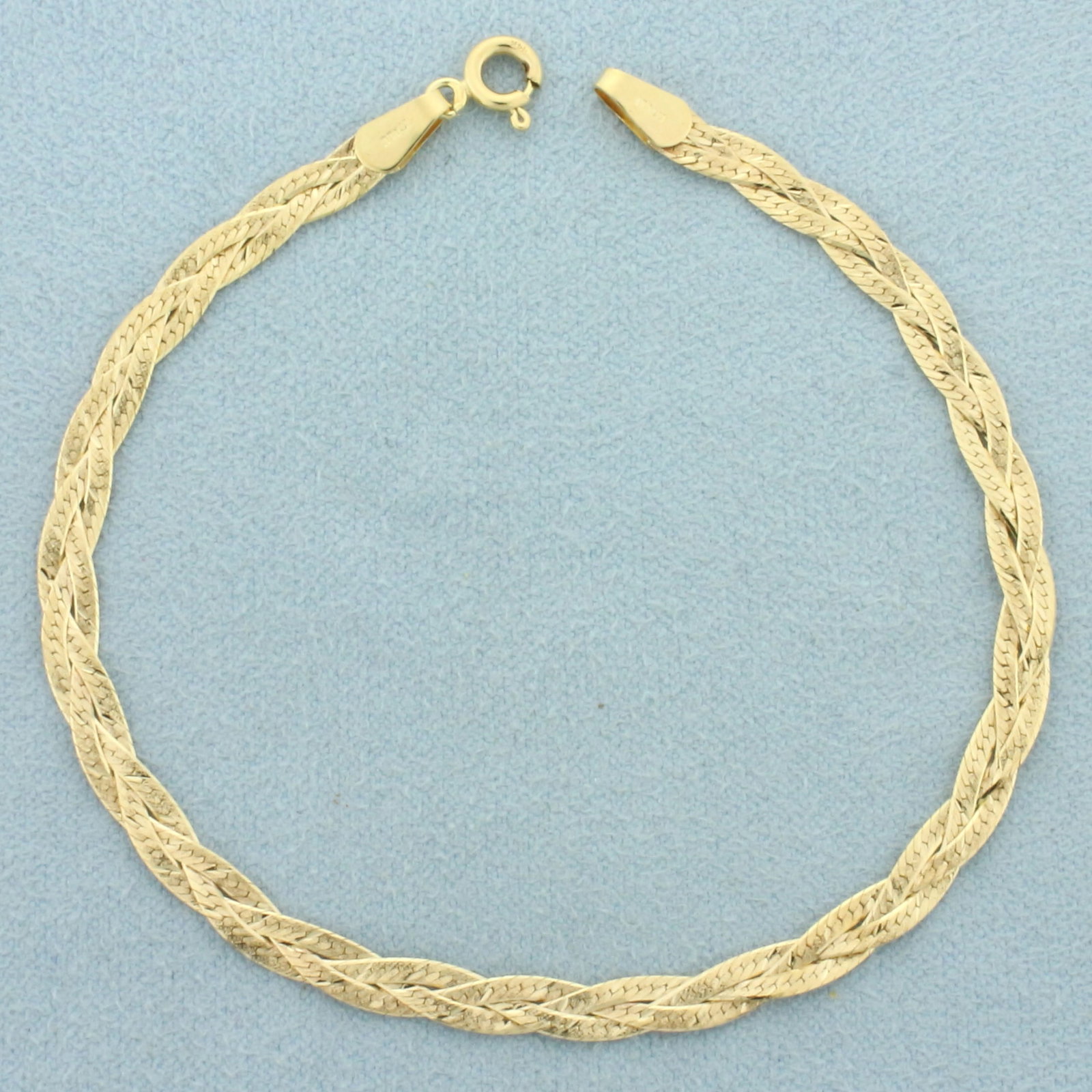 Italian Braided Sandblast Finish Herringbone Link Bracelet in 14k Yellow Gold: In 14k yellow gold. Italian made. 7 inches long and 4mm wide. Spring clasp. 2.8g.