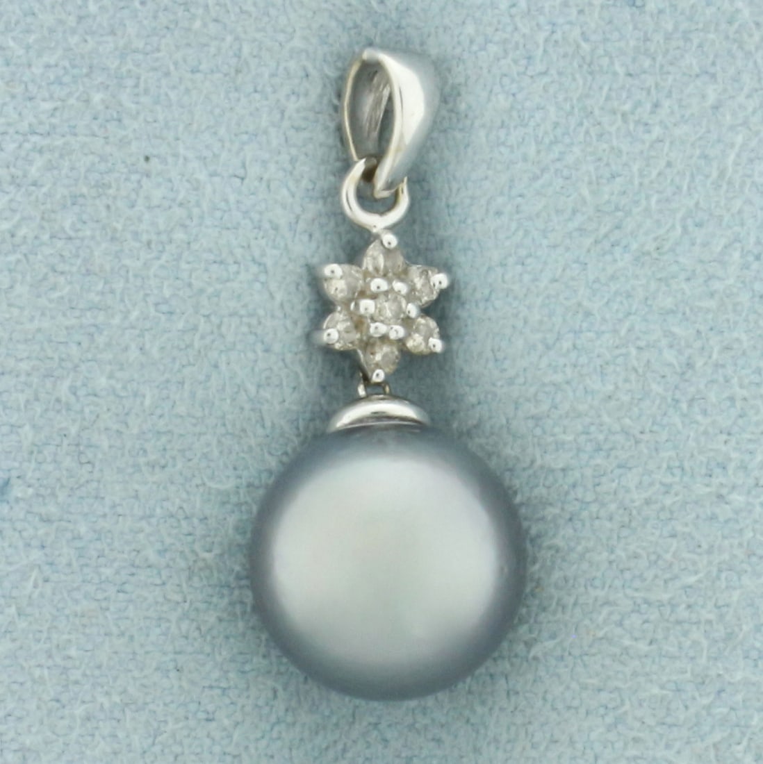 Tahitian Pearl and Diamond Pendant in 14k White Gold: In 14k white gold. Contains 1 high quality 10.3mm natural Tahitian Pearl with silver peacock tone and high luster. Also contains seven high quality 1/2pt diamonds. 1 1/8 inches long and 3/4 inches wid
