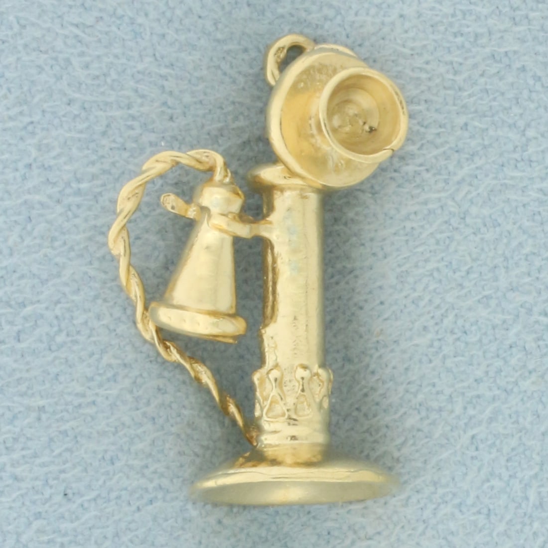 Antique Phone Charm or Pendant in 14k Yellow Gold: in 14k yellow gold. Listening part of phone rotates. 1 inch long and 1/2 inch wide. 3.0g.