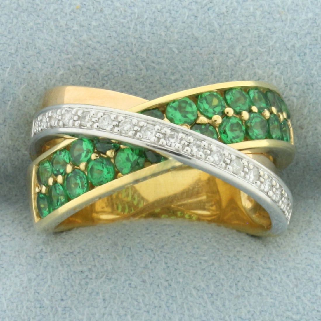 Designer Guy Laroche Tsavorite Garnet and Diamond Criss Cross Ring in 18k Yellow Gold: In 18k white gold. Contains twenty two high quality natural 2.5mm Tsavorite Garnet gemstones with vibrant color and excellent clarity. Also contains seventeen high quality 1/2pt diamonds. 12.3mm wide