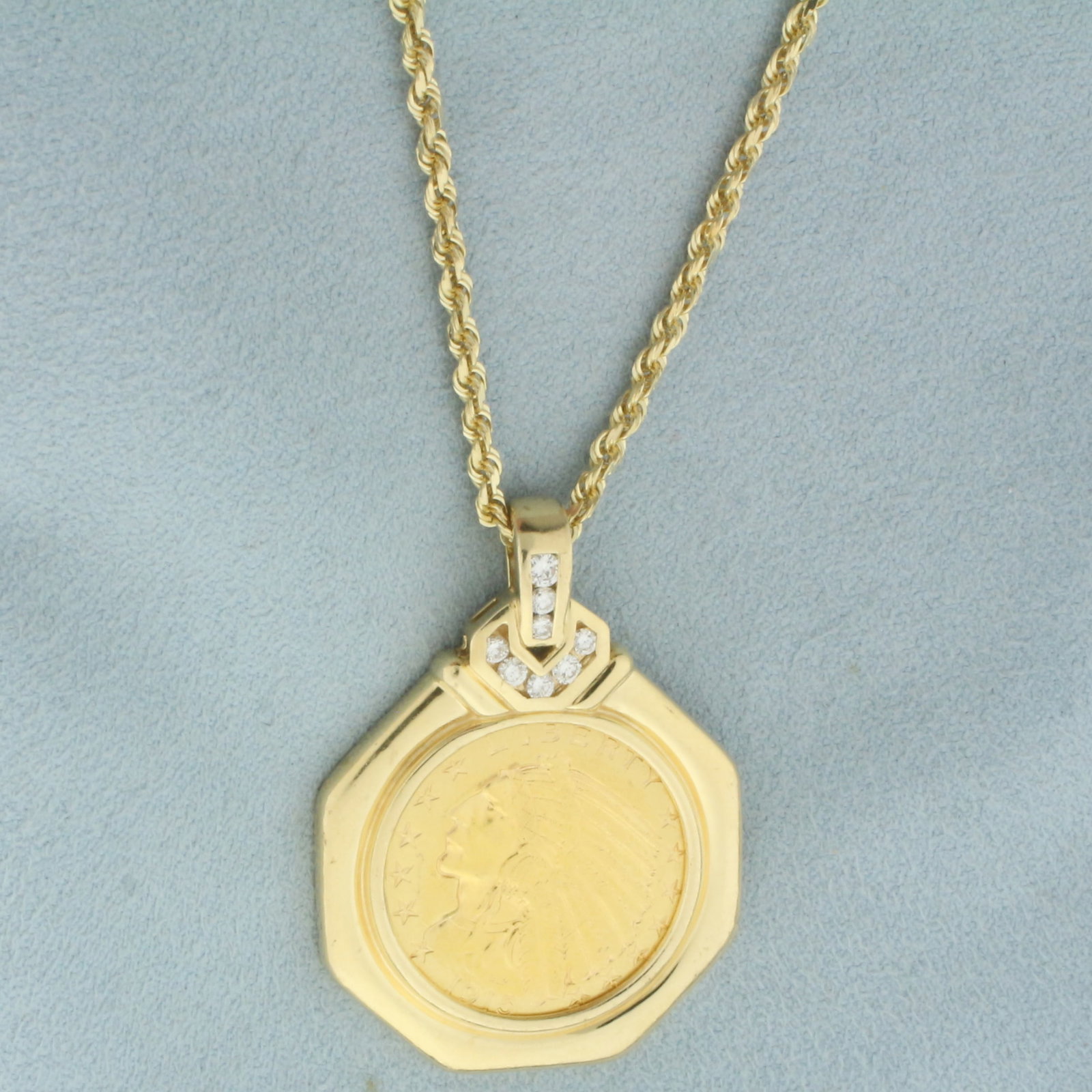 1915 Indian Head Coin Necklace in 14k Yellow Gold: In 14k yellow gold mounting and chain. Coin is a 1915 $5 Indian Head Gold Coin (90% pure gold). Pendant contains eight high quality diamonds, 1/3ct TW, VS clarity/G color. Rope chain is 2mm thick, 24 