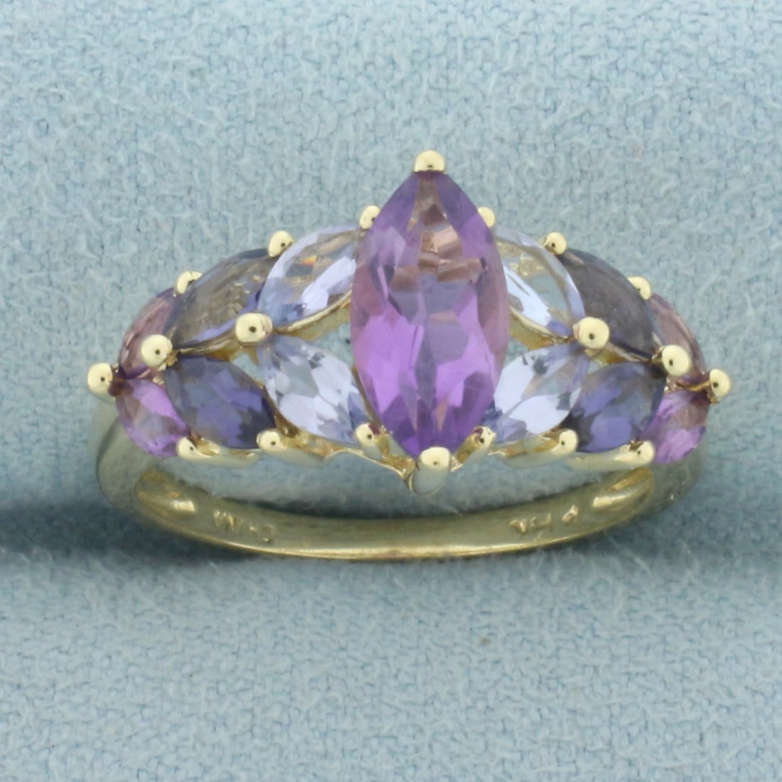 Amethyst, Aquamarine, and Tanzanite Ombre Design Ring in 14k Yellow Gold: In 14k yellow gold. Contains one marquise cut amethyst, 10mm x 5mm, four marquise amethysts, 4mm x 2mm, four marquise cut aquamarines, 5mm x 3mm, and 4 marquise cut tanzanites, 5mm x 3mm. All high qua