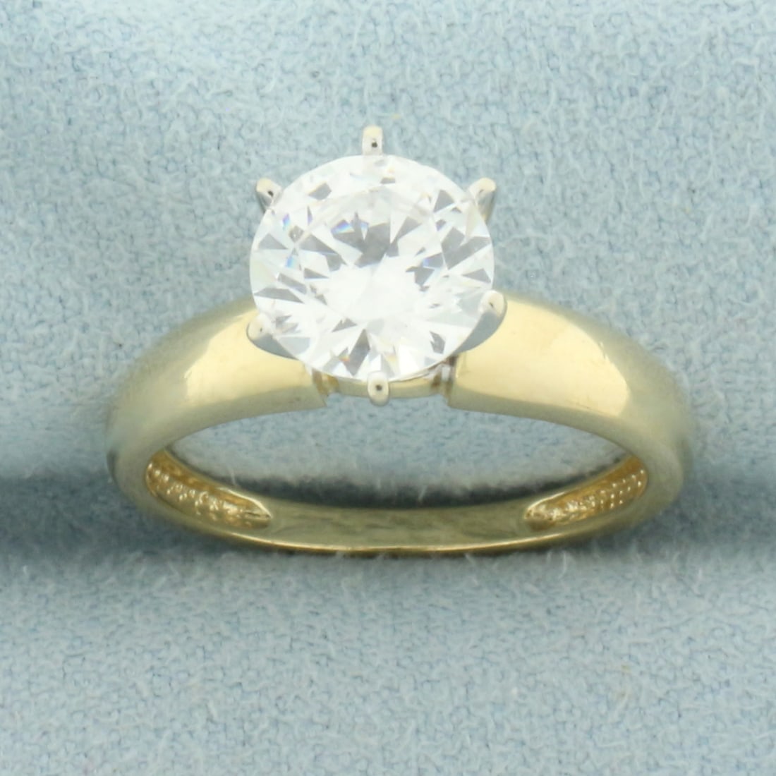 2ct CZ Solitaire Engagement Ring in 14k Yellow Gold: In 14k yellow gold. Contains 1 high quality 2ct cz gemstone with excellent cut and clarity for added brilliance. Size: 7.25. 3.8g.
