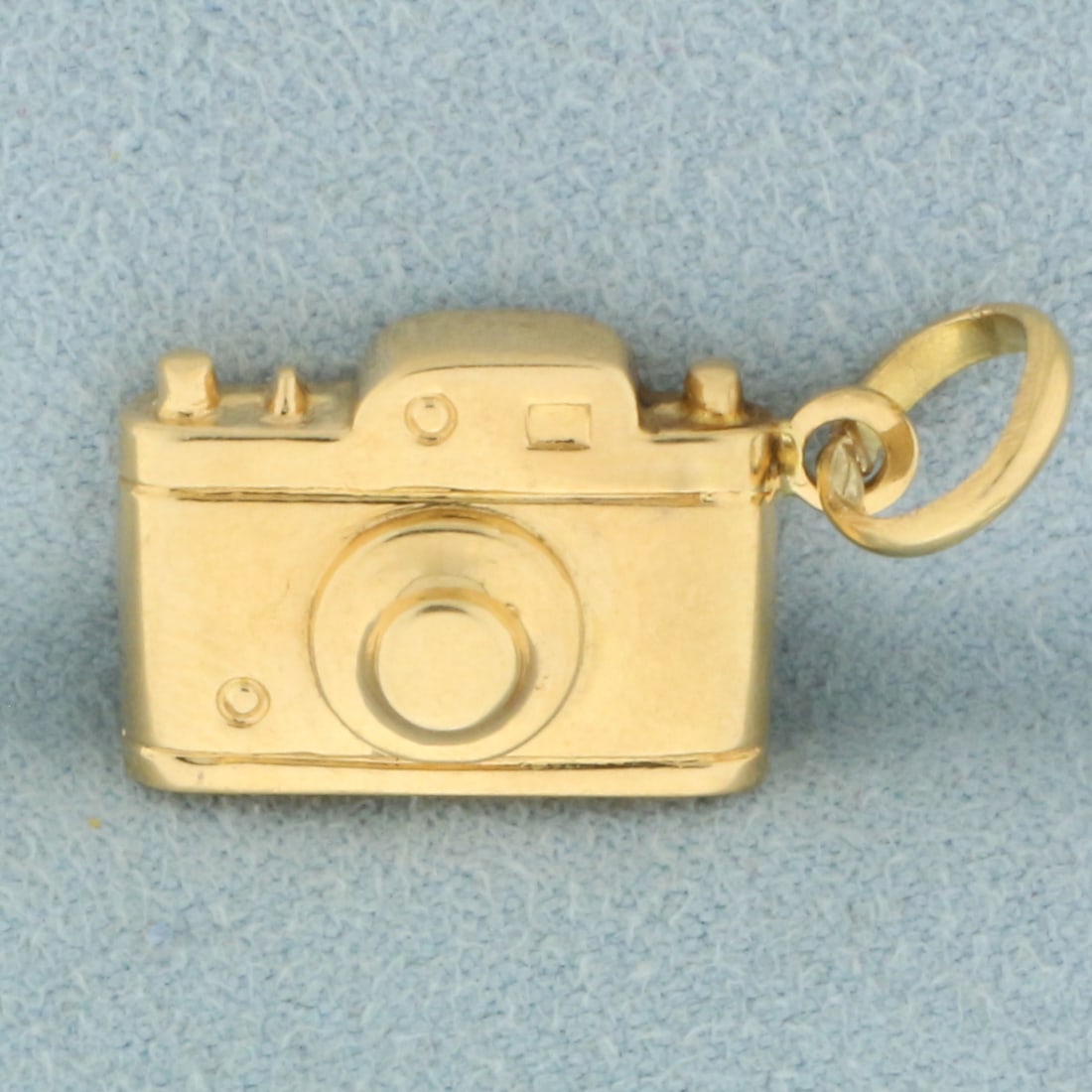 3D Camera Charm in 18k Yellow Gold: In 18k yellow gold. 1 inch long (including jump ring) x 1/2 inches wide. 2.4g.
