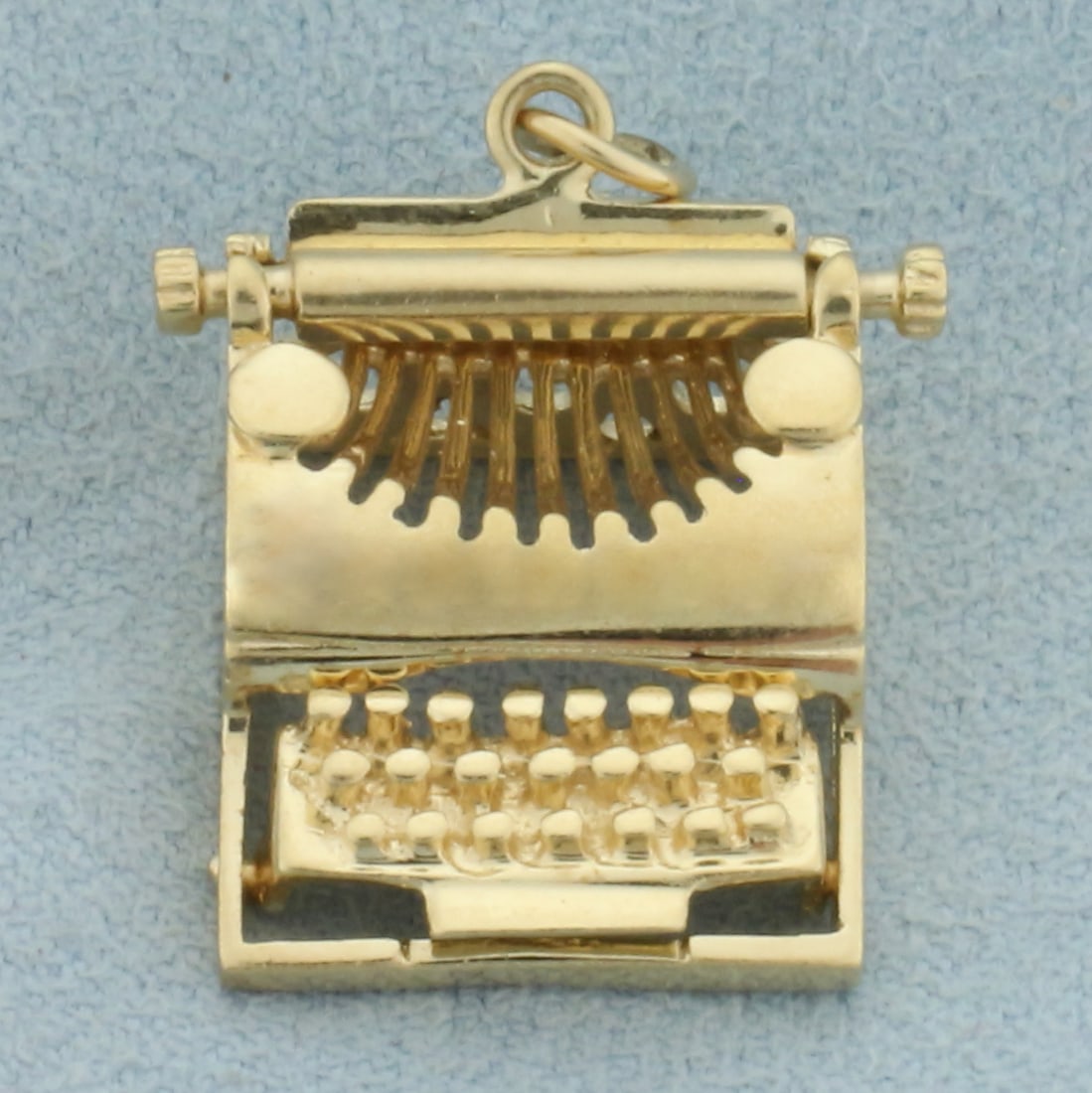Mechanical 3 D Typewriter Charm or Pendant in 14k Yellow Gold: In 14k yellow gold. Approx. 7/8 inches by 3/5 inches. Ribbon spool spins. 4.8g.