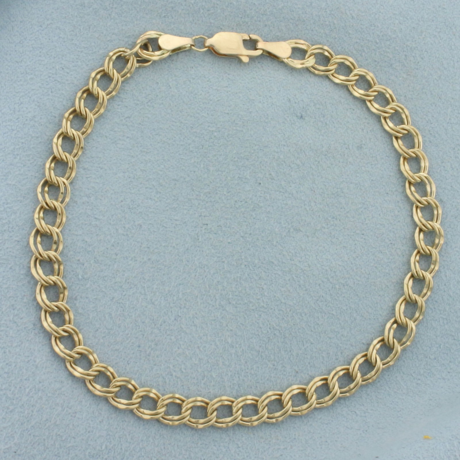 8 Inch Ring Charm Bracelet in 10k Yellow Gold: In 10k yellow gold. 8 inches long and 5mm wide. Lobster clasp. 5.7g.