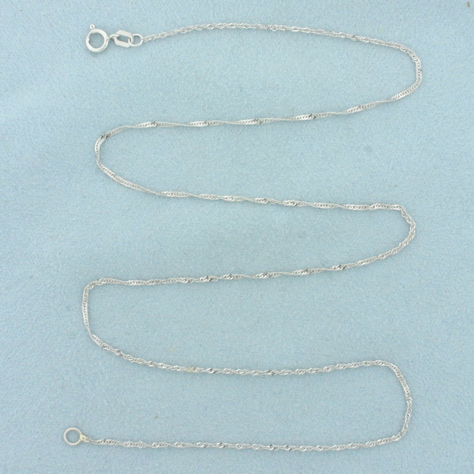 18 Inch Twisting Curb Link Chain Necklace in 10k White Gold: In 10k white gold. 18 inches long and 1.1mm wide. Spring clasp. 1.0g.