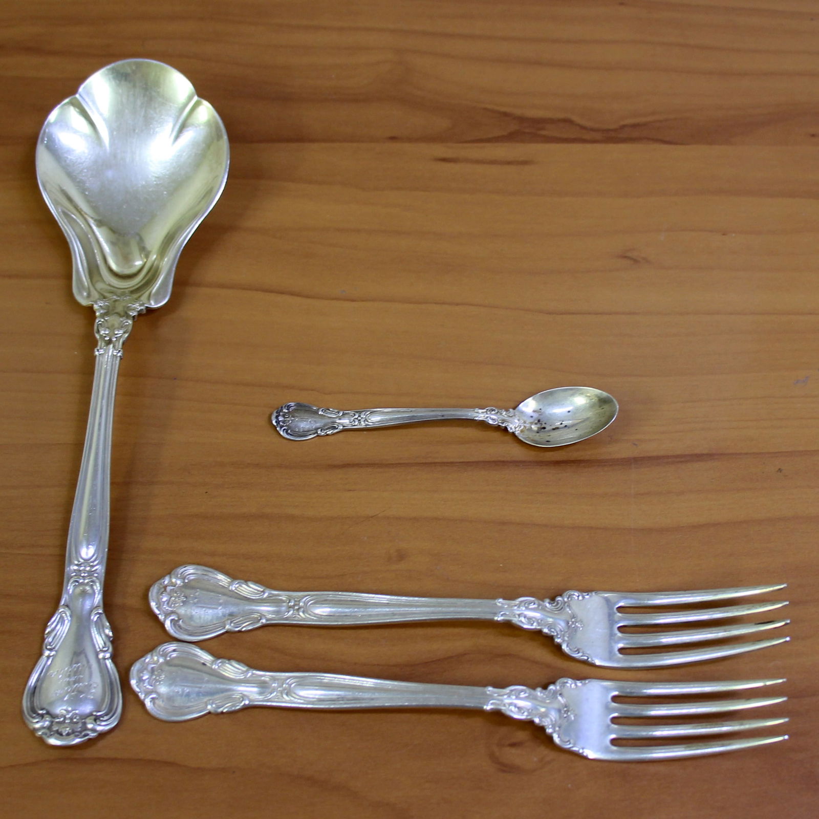 Vintage Set of 4 Piece Gorham Chantilly Sterling Silver Flatware: .925 sterling silver, marked lion anchor G (old marks). 1 Large Rare solid Berry/Casserole Spoon 8.75 inches light goldwash "Father and Mother "and "1859 1909" engraving. 2 forks 6.75 inches "W" or "M
