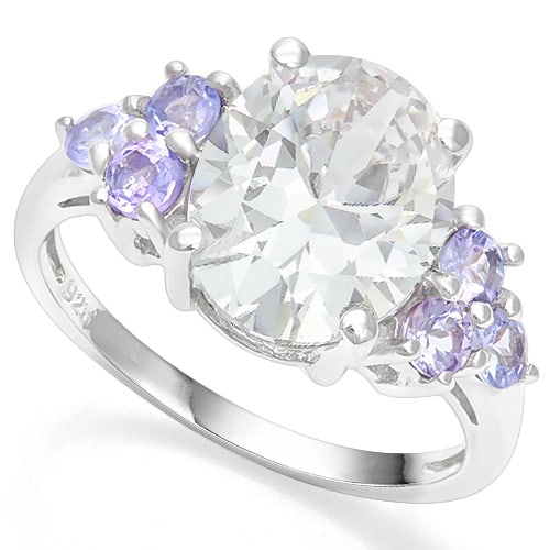 Huge White Topaz & Tanzanite Statement Ring in Sterling Silver: Platinum over sterling silver. Contains one 4.4ct oval cut white topaz and size tanzanite gemstones, 2/3ctw. Size 7. 3.4g