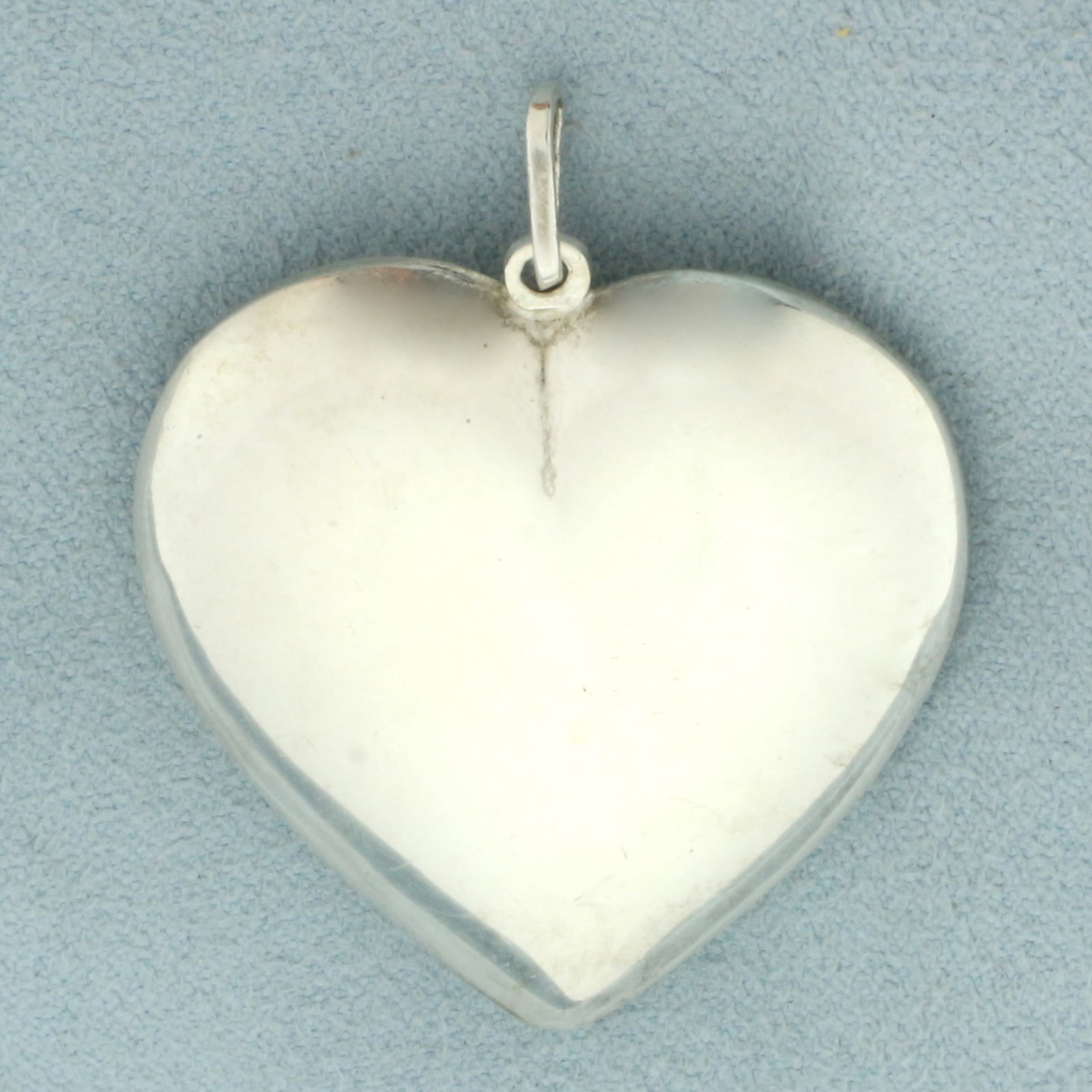 Large Puffy Heart Pendant in Sterling Silver: In .925 sterling silver. 1 5/8 inches long (including bail) and 1 1/4 inches wide. 6.6g.