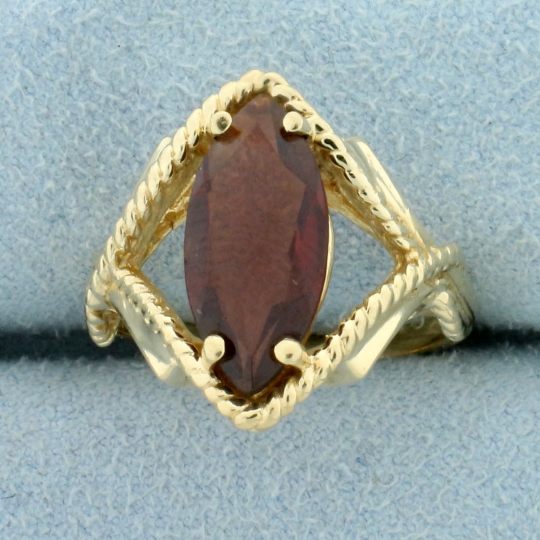 2.5ct Garnet Rope Design Ring in 14K Yellow Gold: In 14K Yellow Gold. Contains one high quality natural 15x7mm marquise Garnet gemstone with beautiful color and excellent clarity. Size 6 3/4. 5.5g.