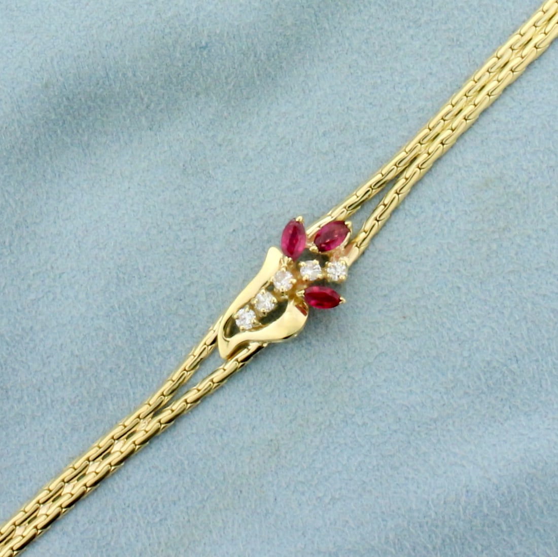 Italian Made 3/4ct TW Ruby and Diamond Flower Design Bracelet in 14K Yellow Gold: In 14K Yellow Gold. Contains three high quality natural ruby gemstones, 1/2ct TW, with bright color and excellent clarity. Also contains five high quality Diamonds, 1/14ct TW, SI clarity/H color. 7 in