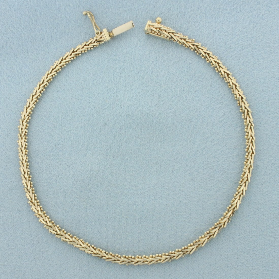 Fancy V Link Bracelet in 14k Yellow Gold: In 14k yellow gold. 7 3/8 inches long. 3.1mm wide. Safety clasp. 6.3g.