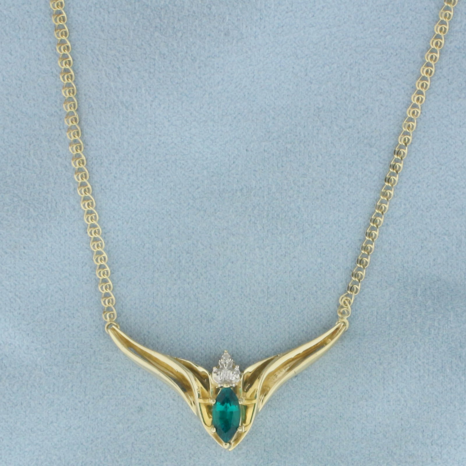 Green Garnet and Diamond V Necklace in 10k Yellow Gold: In 10k yellow gold. Contains one high quality 8mm Green Garnet gemstone with vibrant color and excellent clarity. Also contains one high quality .01ct diamond, SI clarity/I clarity. 18.25 inches long,