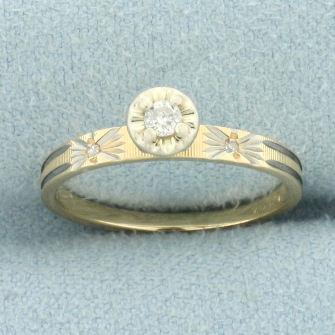 Vintage Diamond Engagement or Promise Ring in 14k Yellow and White Gold: In 14k yellow and white gold. Center diamond is .05ct round brilliant diamond, I color/I clarity. Also contains two high quality 1/2pt diamonds in shank. Size: 5. 1.6g.