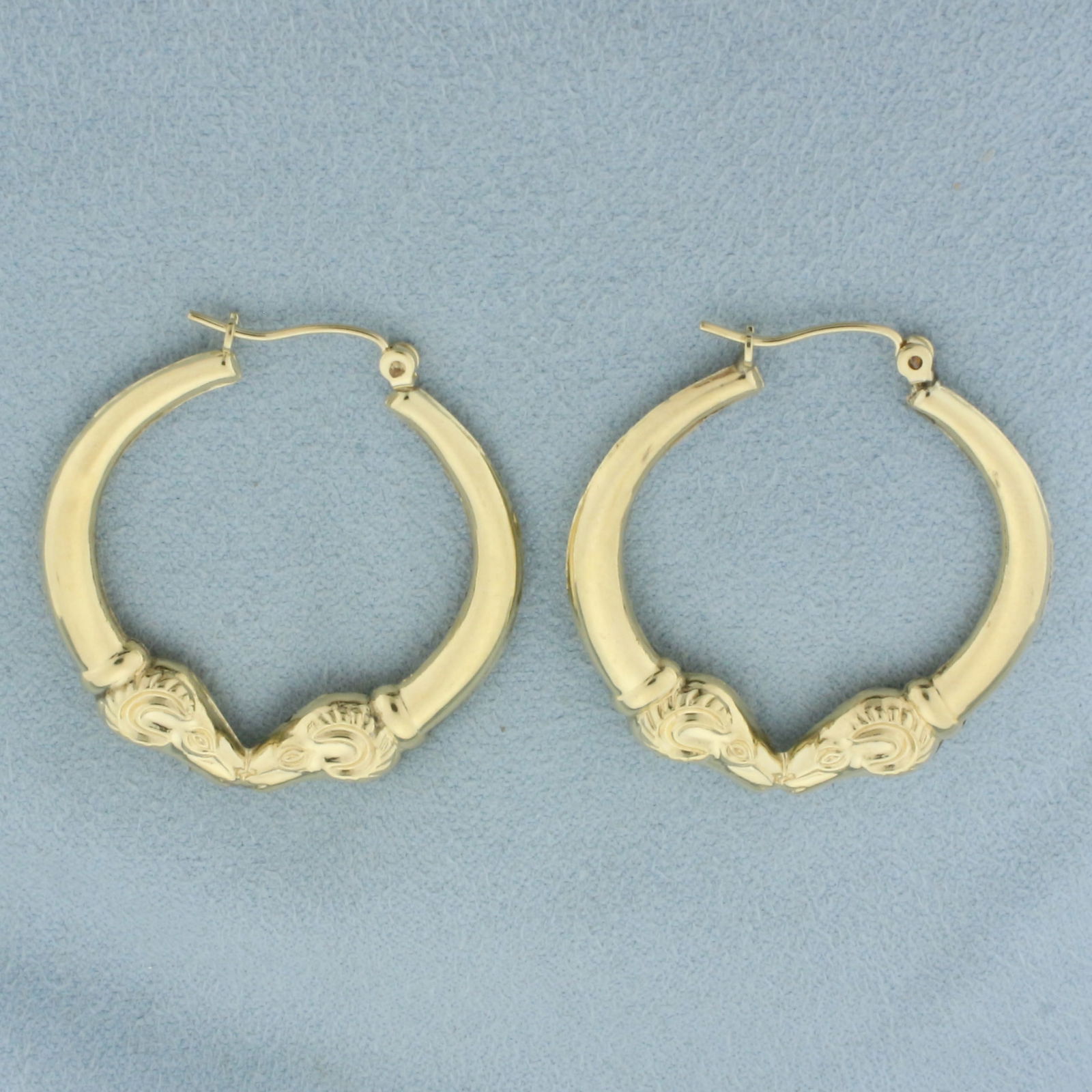 Vintage Double Ram's Head Hoop Earrings in 14k Yellow Gold: In 14k yellow gold.1 3/8 inches long and 1 1/4 inches wide. Minor indentations, indicative of age, not noticeable. 3.2g.