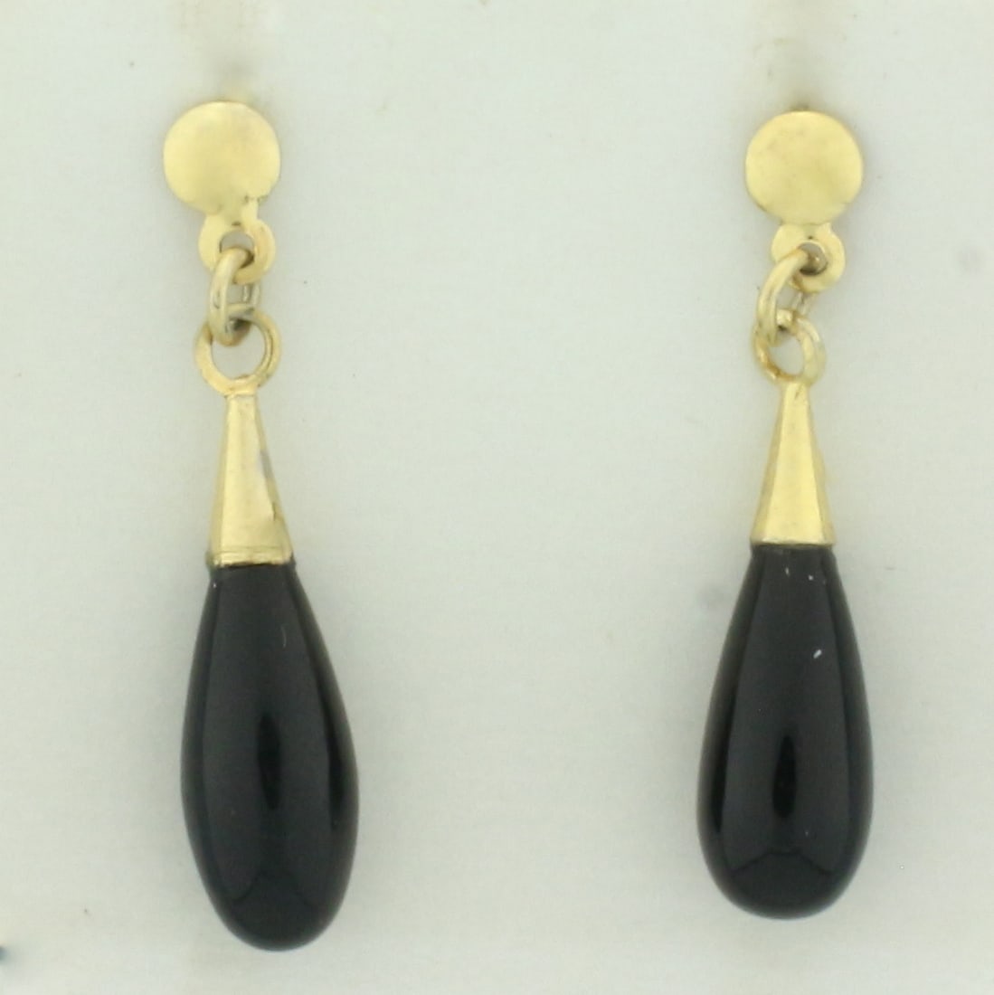 Onyx Teardrop Dangle Earrings in 14k Yellow Gold: In 14k yellow gold. Contains two high quality 14mm by 6mm teardrop onyx gemstones. 1 1/8 inches long. Friction backs. 2.0g.