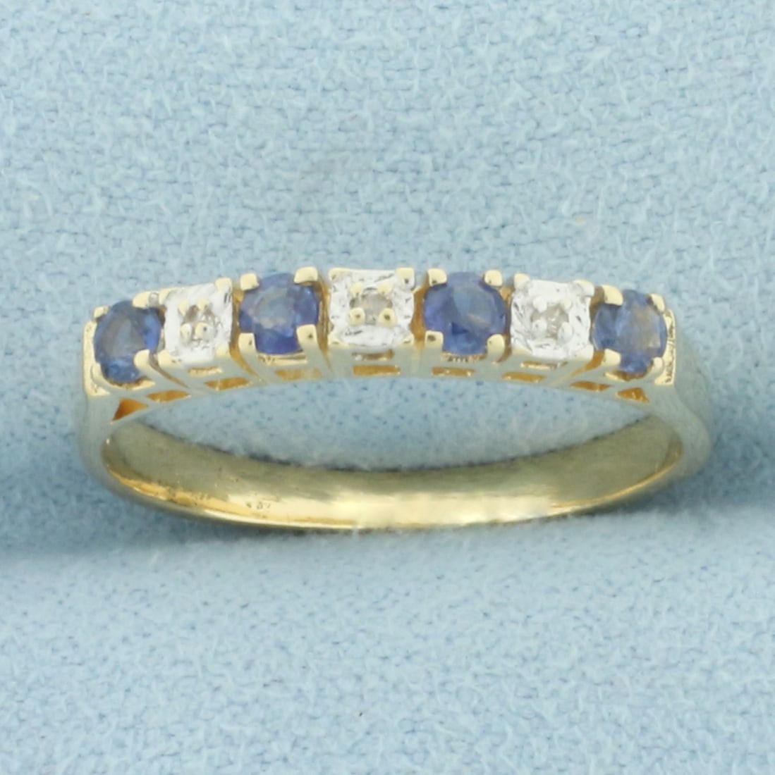 Alternating Sapphire and Diamond Stacking Band Ring in 14k Yellow Gold: In 14k yellow gold. Contains four high quality natural 2.5mm Sapphire gemstones with bright color and excellent clarity. Also contains three high quality 1/2pt diamonds. 2.7mm wide. Size: 7.75. 2.2g.