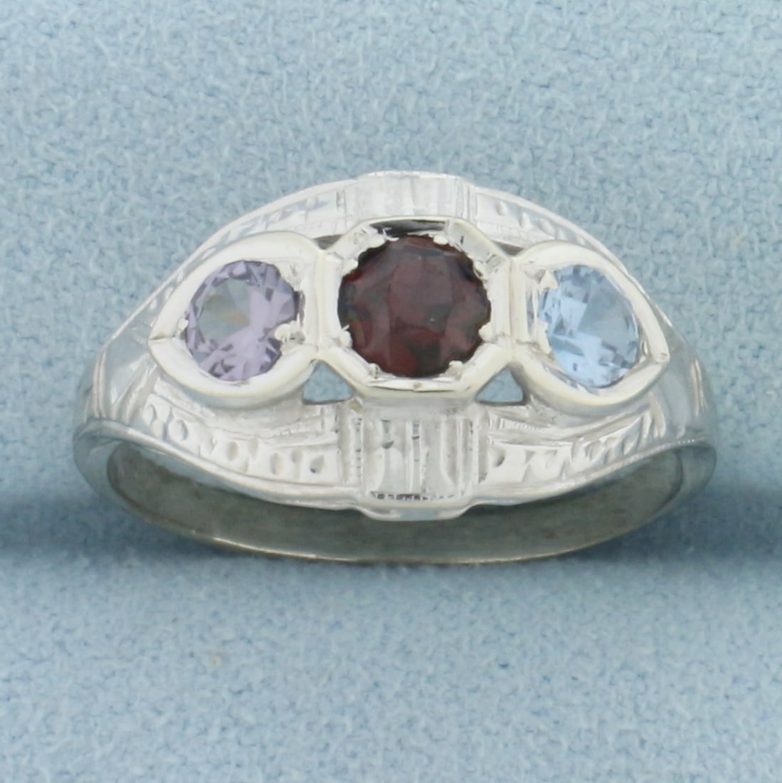 Garnet, Blue Topaz, and Sapphire Deco 3 Stone Ring in 14k White Gold: In 14k white gold. Contains one 4mm Garnet, one 3.5mm Blue Topaz, and one 3.5mm Sapphire high quality natural gemstones with vibrant color and excellent clarity. Size: 8. 3.0g.