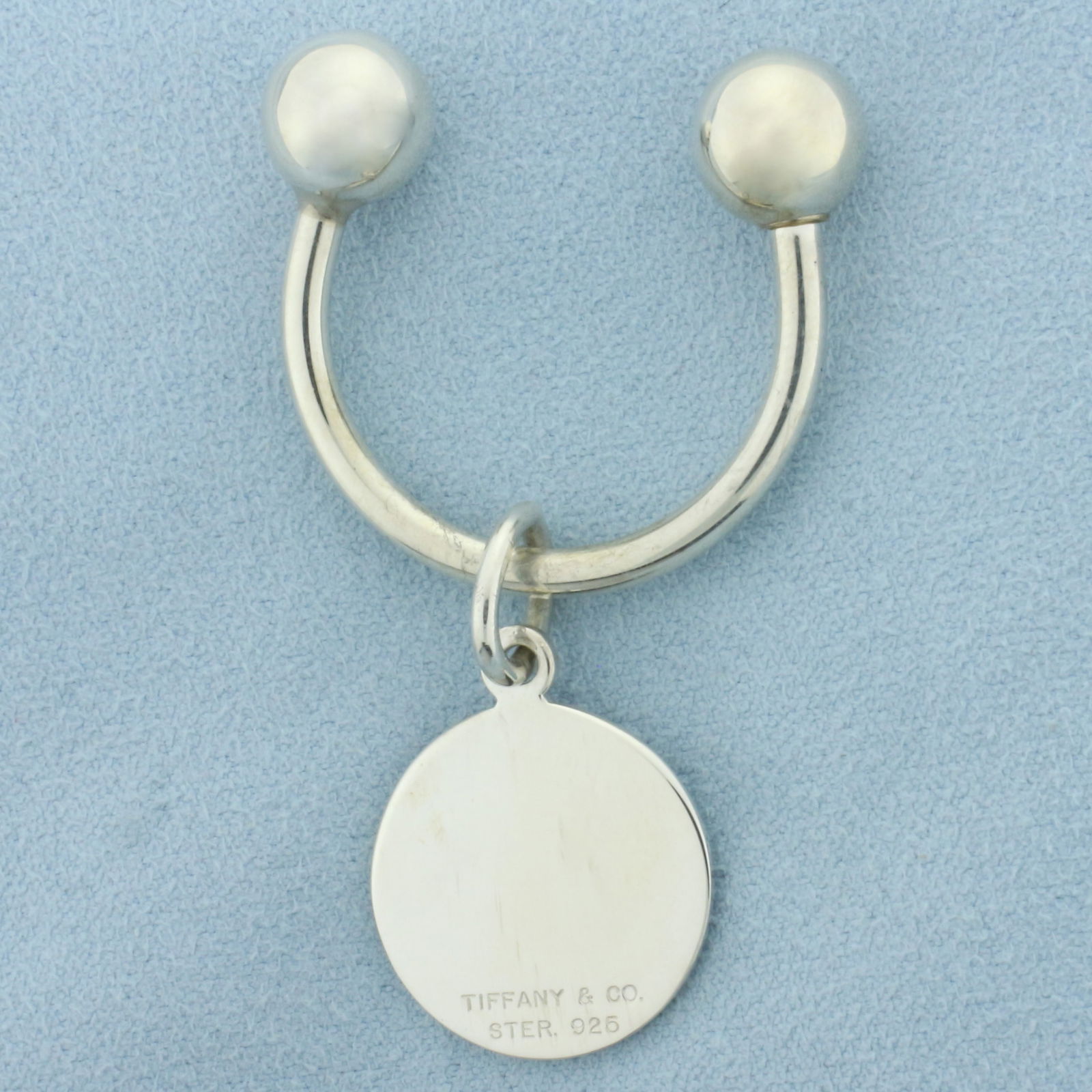 Tiffany and Co. Sterling Silver Key Ring in Sterling Silver: In .925 sterling silver. Guaranteed Authentic. 2 1/4 inches long and 1 1/4 inches wide. 9.7g.