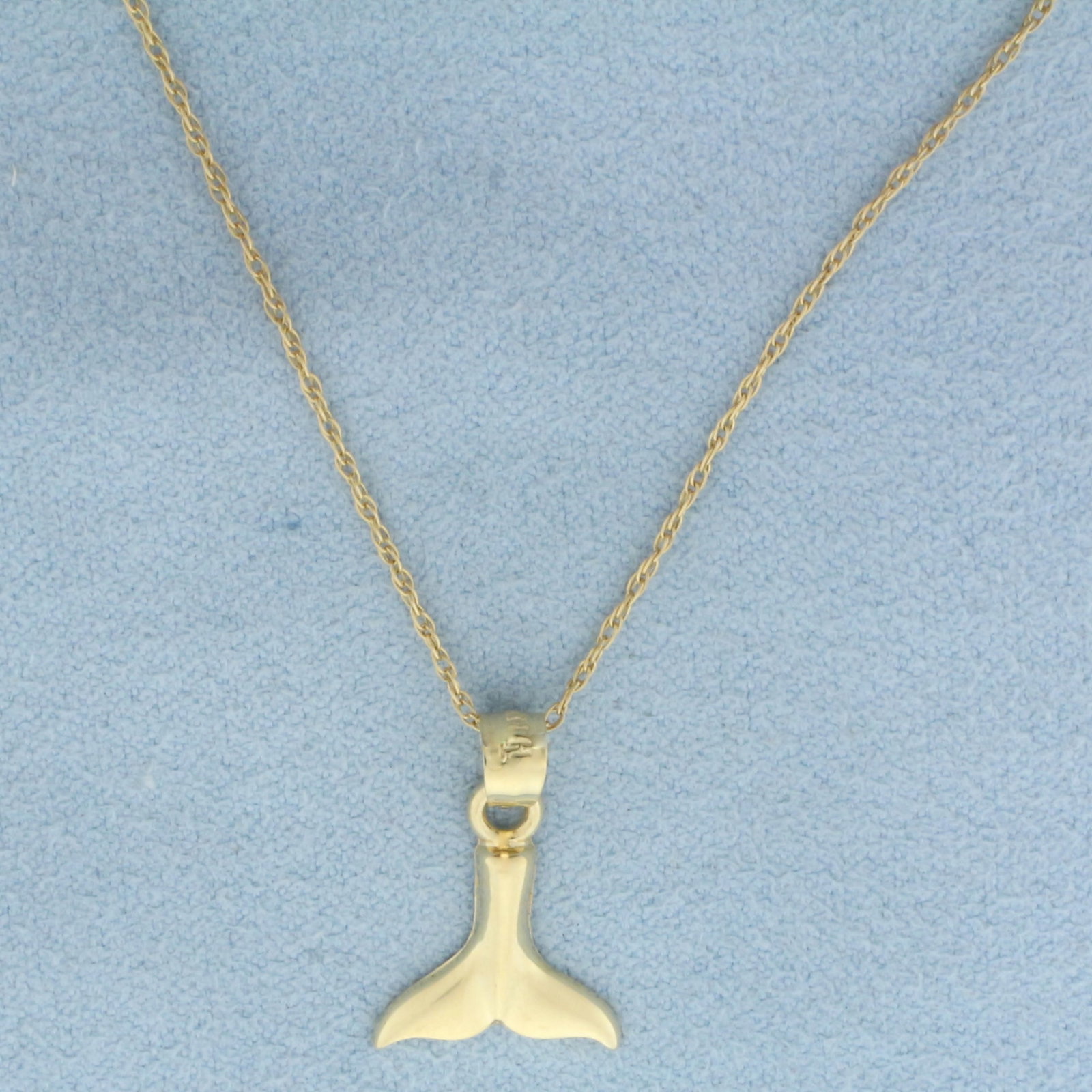 Whale Tail Necklace in 14k Yellow Gold: In 14k yellow gold. Prince of Wales Chain is 16.5 inches, 1mm wide, spring clasp. Pendant is 3/4 inch long (including bale) and 1/2 inches wide. 1.5g.