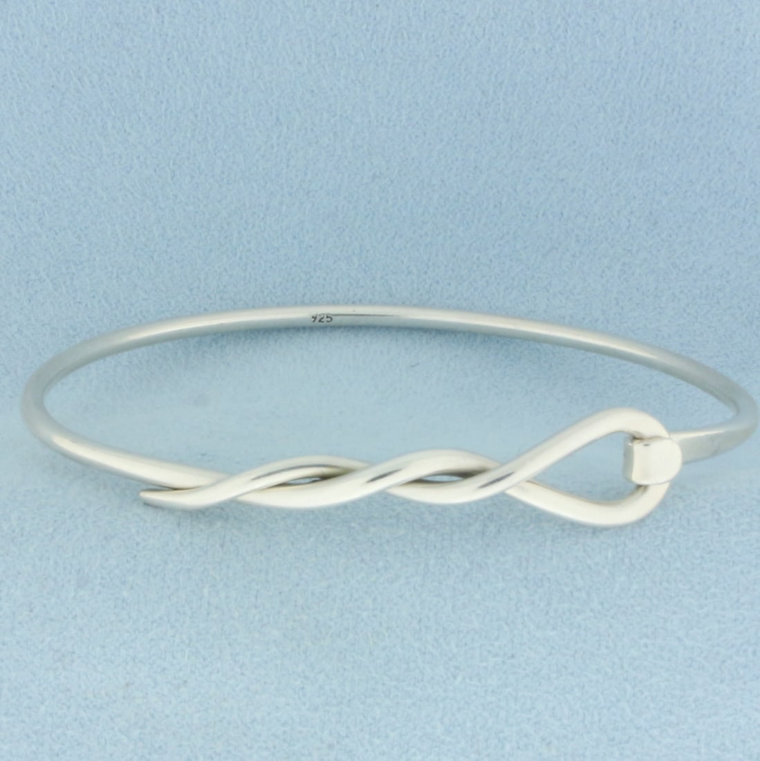Woven Design Bangle Bracelet in Sterling Silver: In .925 sterling silver. 2 1/2 inch inner diameter. 10mm wide at widest point. 10.0g