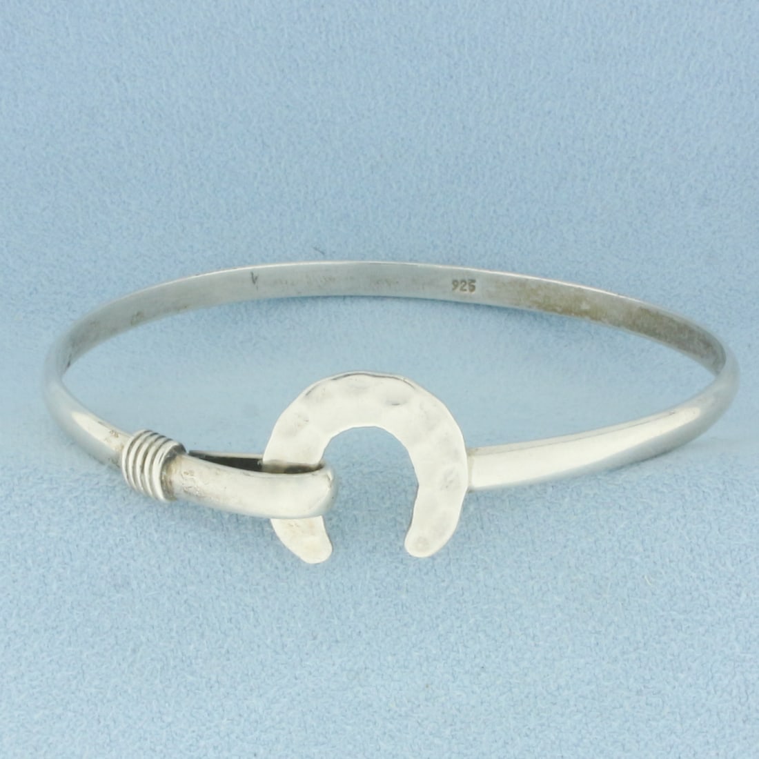 Horseshoe Bangle Bracelet in Sterling Silver: In .925 sterling silver. 2 3/8 inches inner diameter and 3.8mm wide. 11.2g