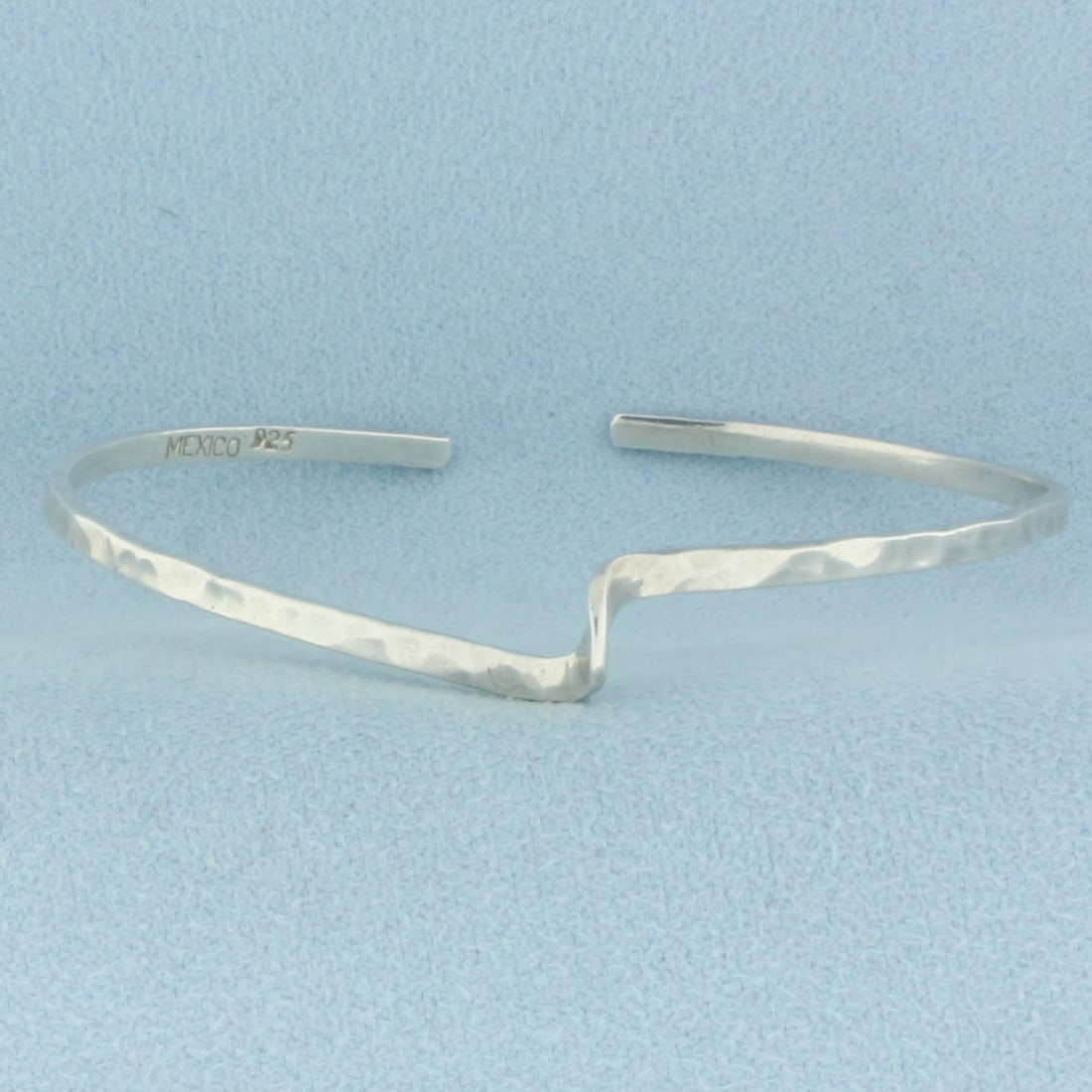 Hammered Finish Bangle Bracelet in Sterling Silver: In .925 sterling silver. 2 3/8 inch inner diameter. 2.4mm wide. 5.0g