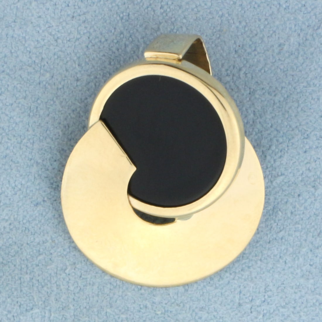 Onyx Disc Pendant or Slide in 14k Yellow Gold: In 14k yellow gold. Contains one high quality 15mm Onyx gemstone. 1 inch long and 3/4 inch wide. 3.5g.
