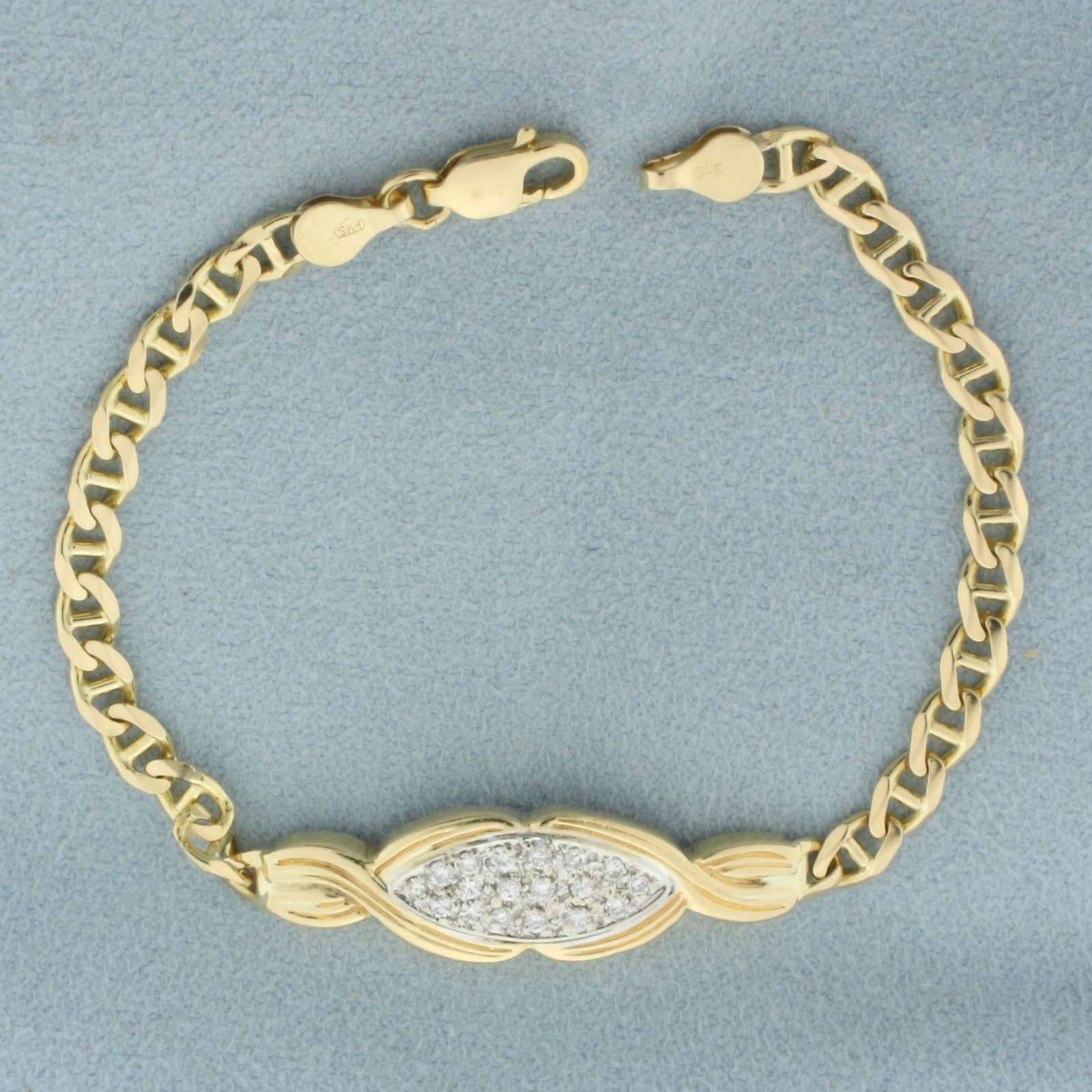 Diamond Anchor Link Bracelet in 10k Yellow Gold: In 10k yellow gold with 14k yellow gold lobster clasp. Contains 18 high quality .02ct diamonds, VS clarity/H color. 6 1/4 inches long x 3/8 inches wide at center. Lobster clasp. 6.2g.