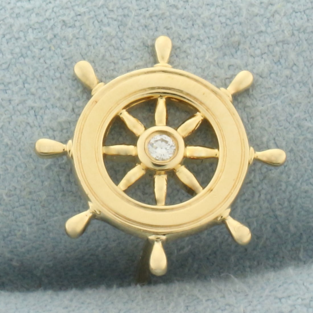Diamond Helm Ship's Wheel Pin Tie Tack in 14k Yellow Gold: In 14k yellow gold. Contains one high quality .05ct diamond, VS clarity/G color. 5/8 inch diameter. 4.1g.
